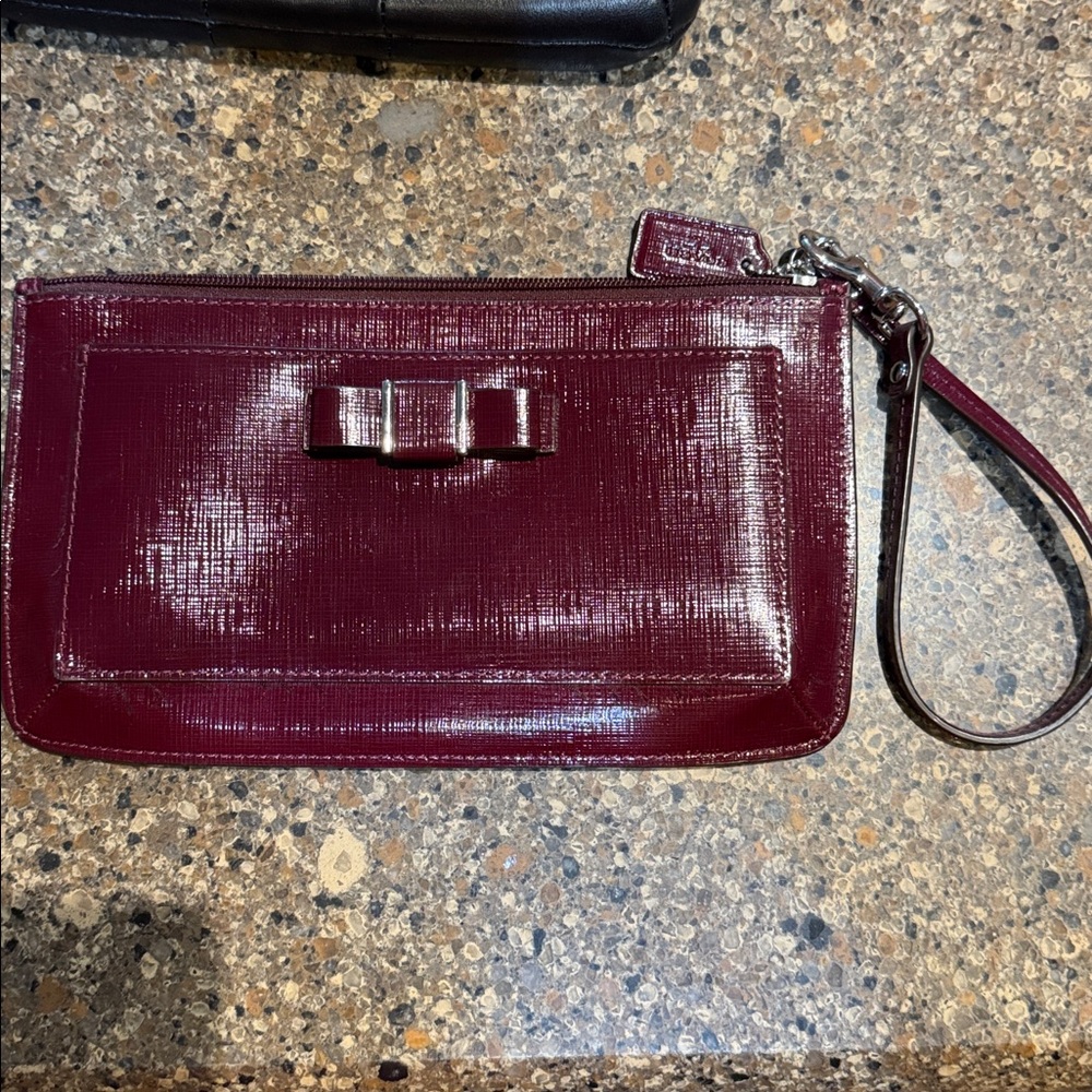 Burgundy Coach envelope style wristlet with Bow Accent